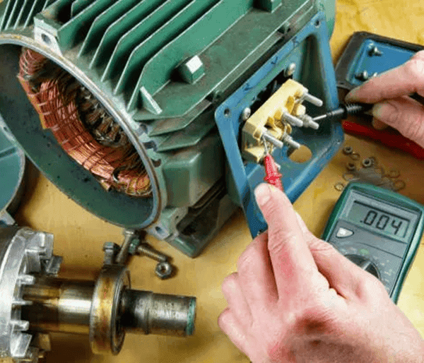 Technician repairing industrial cleaning machine motor